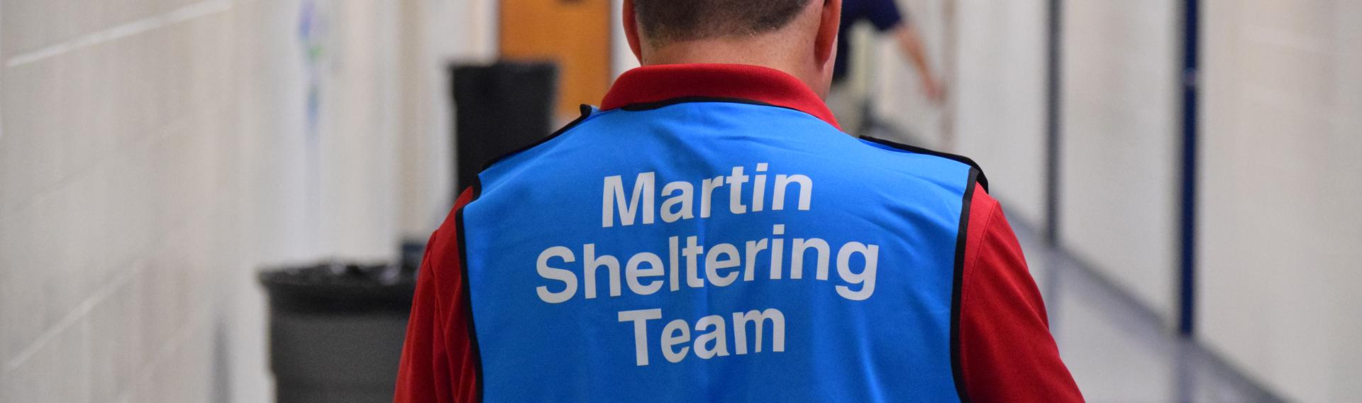 Volunteer wearing a vest that says Martin Shelter Team 