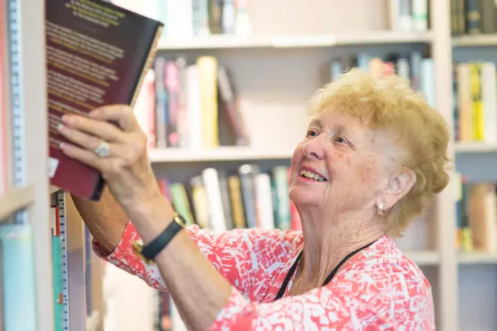Photo of a library volunteer in Bonnie's Books bookstore at the Blake Library in Stuart