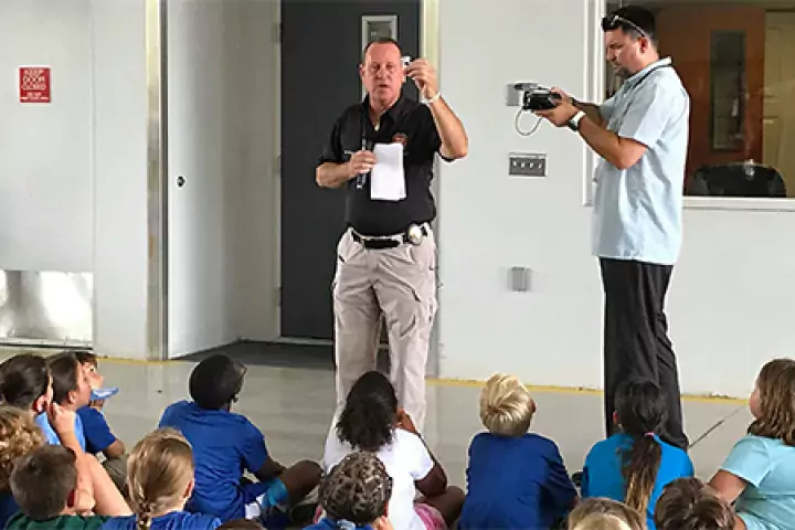 An instructor leading a fire safety class to children