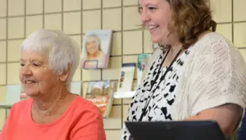 librarian helping a patron on a computer