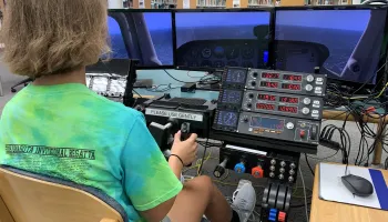 A teenager using the flight simulator