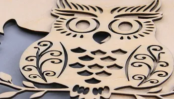 An owl design cut out of wood