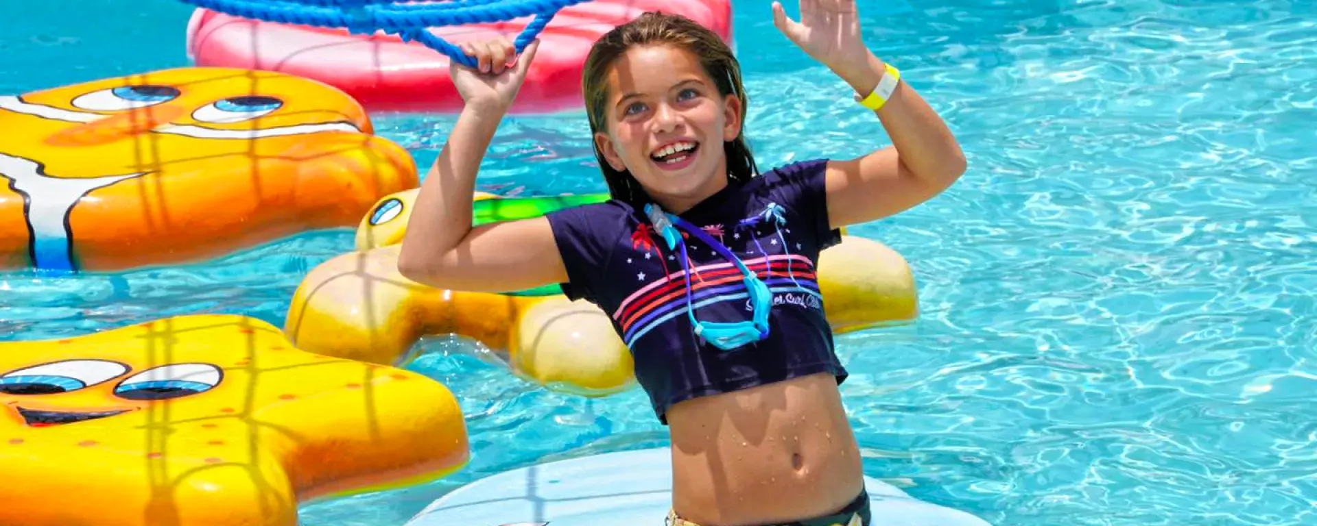 Image of a young girl playing on the wiggly waters attraction at Sailfish Splash Waterpark in Stuart, FL.