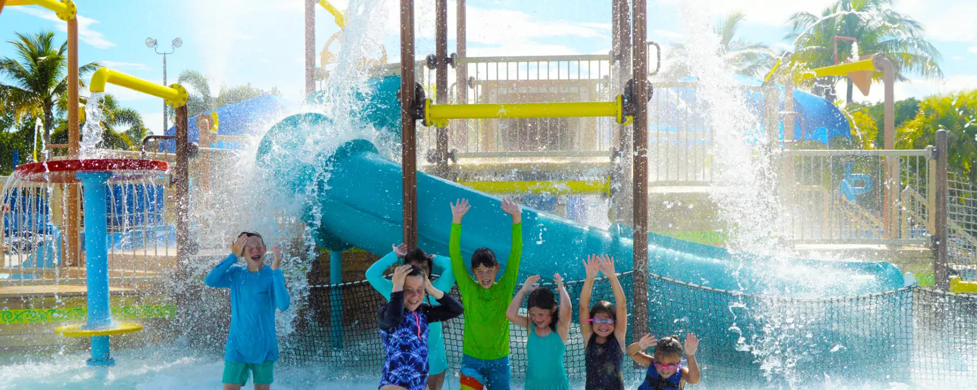 Image of a group of children laughing at the splash playground at Sailfish Splash Waterpark in Stuart, FL.