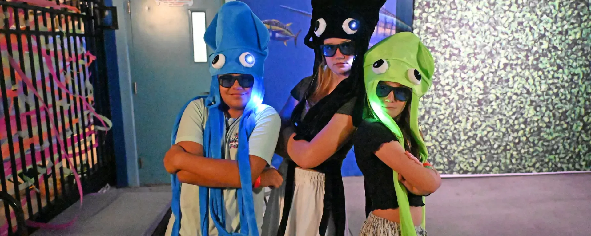 Teens dressed with squid hats at Sailfish Splash Waterpark during a teen night event.