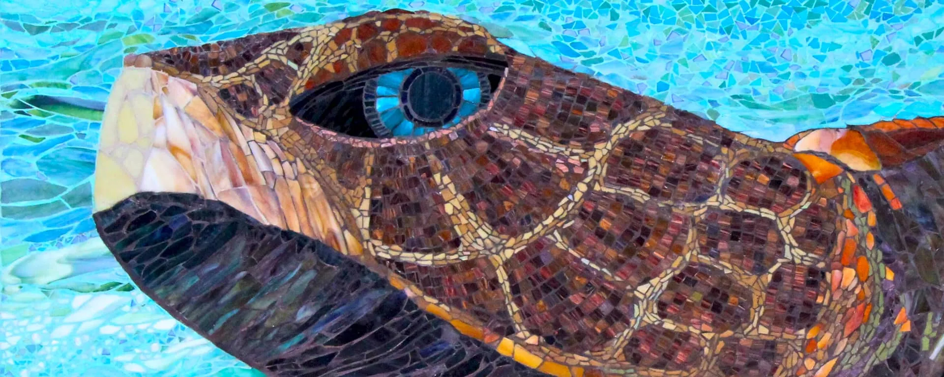 A turtle art piece made of colorful mosaic tiles