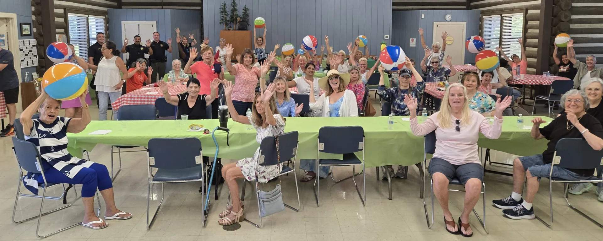 Large group of seniors having fun at a BBQ event at the Log Cabin Senior Center