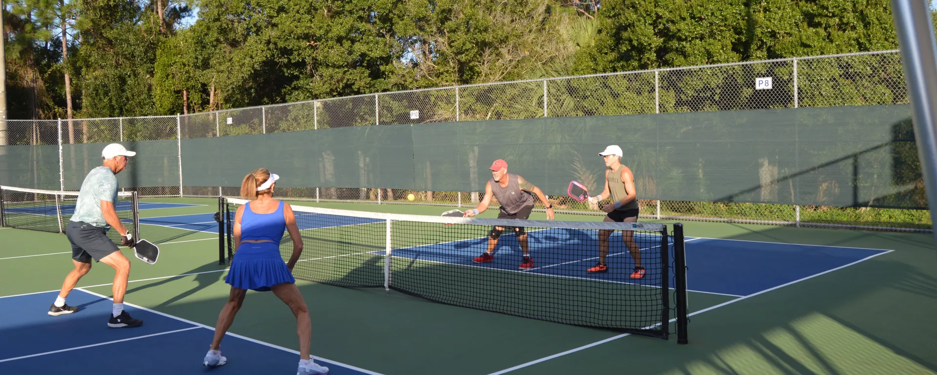 4 people playing pickleball