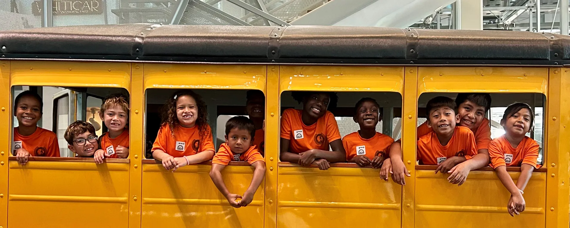 Summer camp kids inside of a school bus