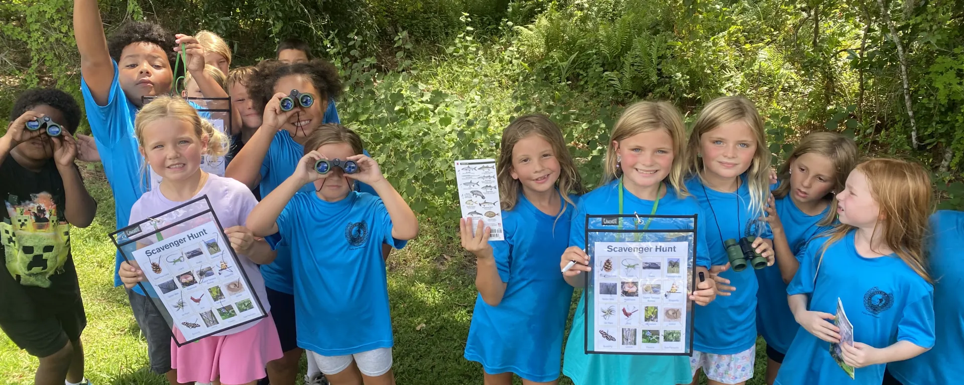 Summer camp kids during a scavenger hunt outdoors