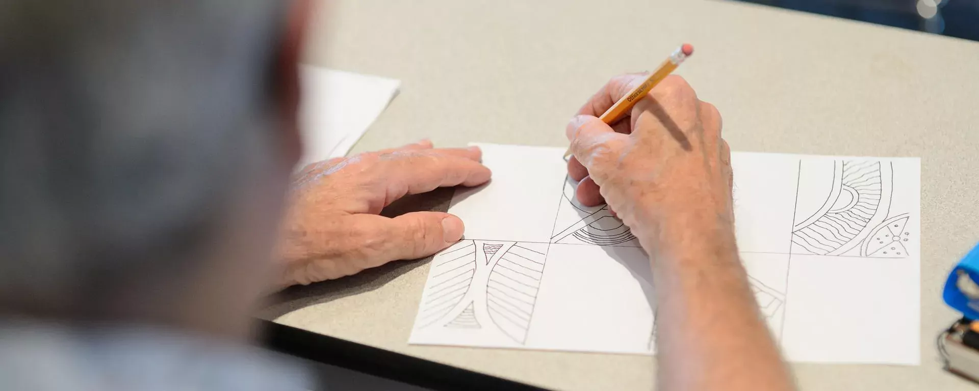 hands drawing a picture at a free library event
