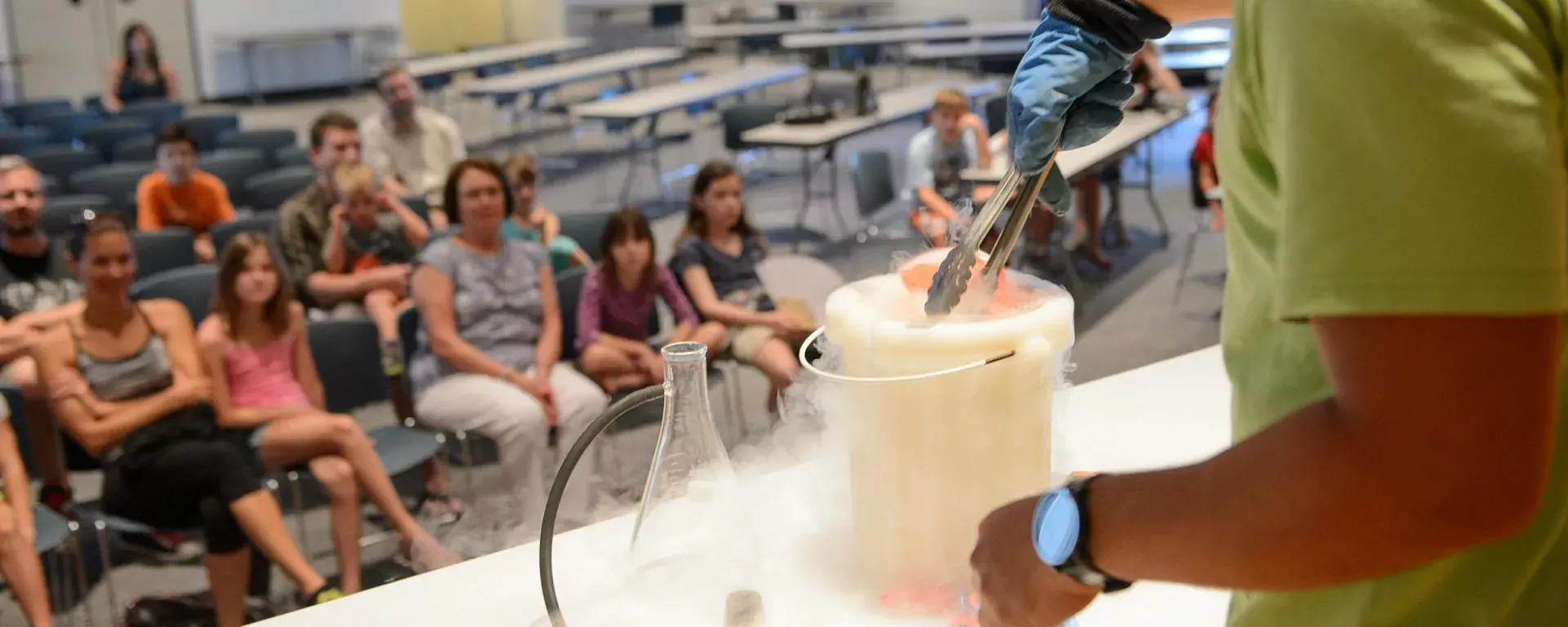 Picture of a liquid nitrogen science experiment as children watch