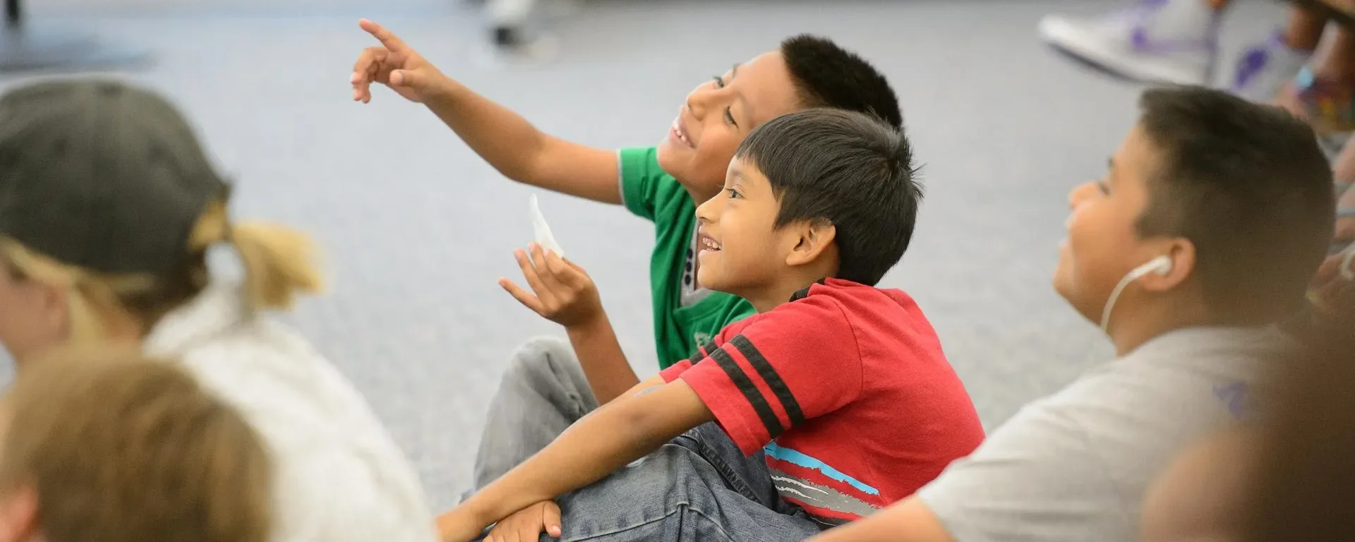 kids pointing and smiling