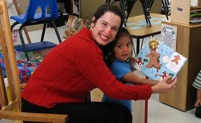A woman reading a book to a child