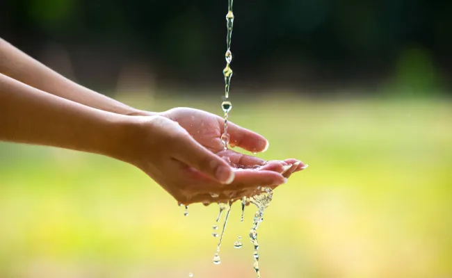Water pouring into hands.