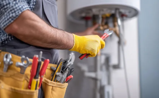 A man performing maintenance using a variety of tools. 