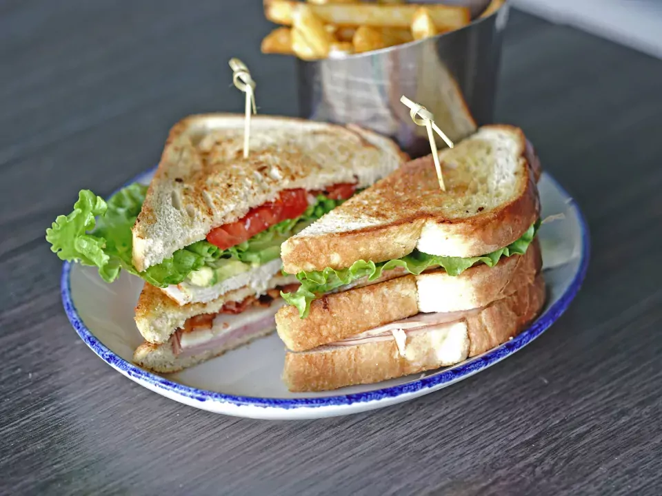 Image of the Sailfish Sands Sands Wedge sandwich with a side of fries