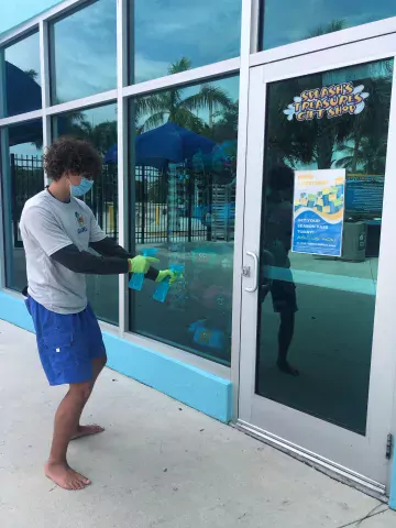 Employee cleaning windows