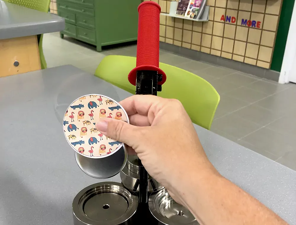 A button being made at the library