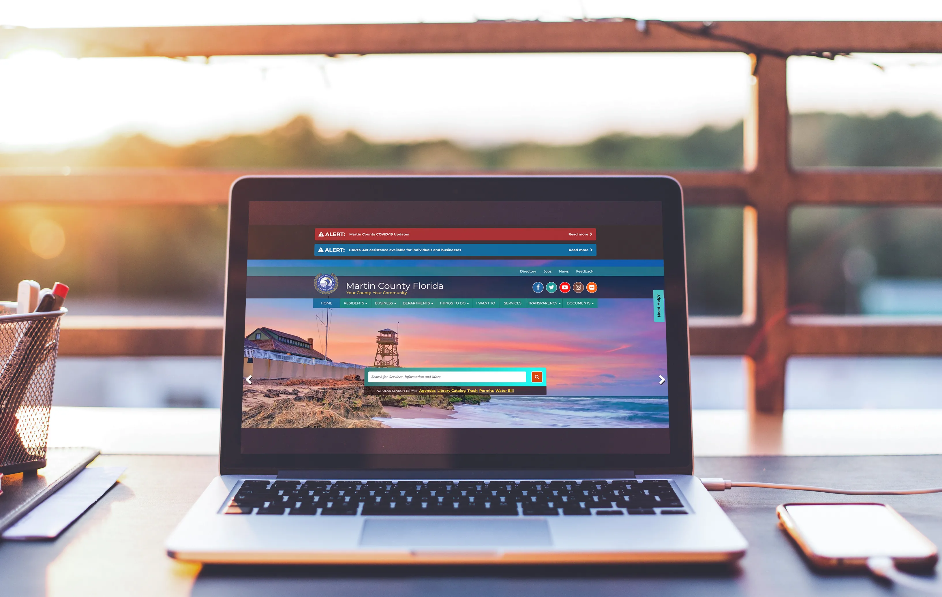 Laptop on a table outdoor showing home page of Martin County website