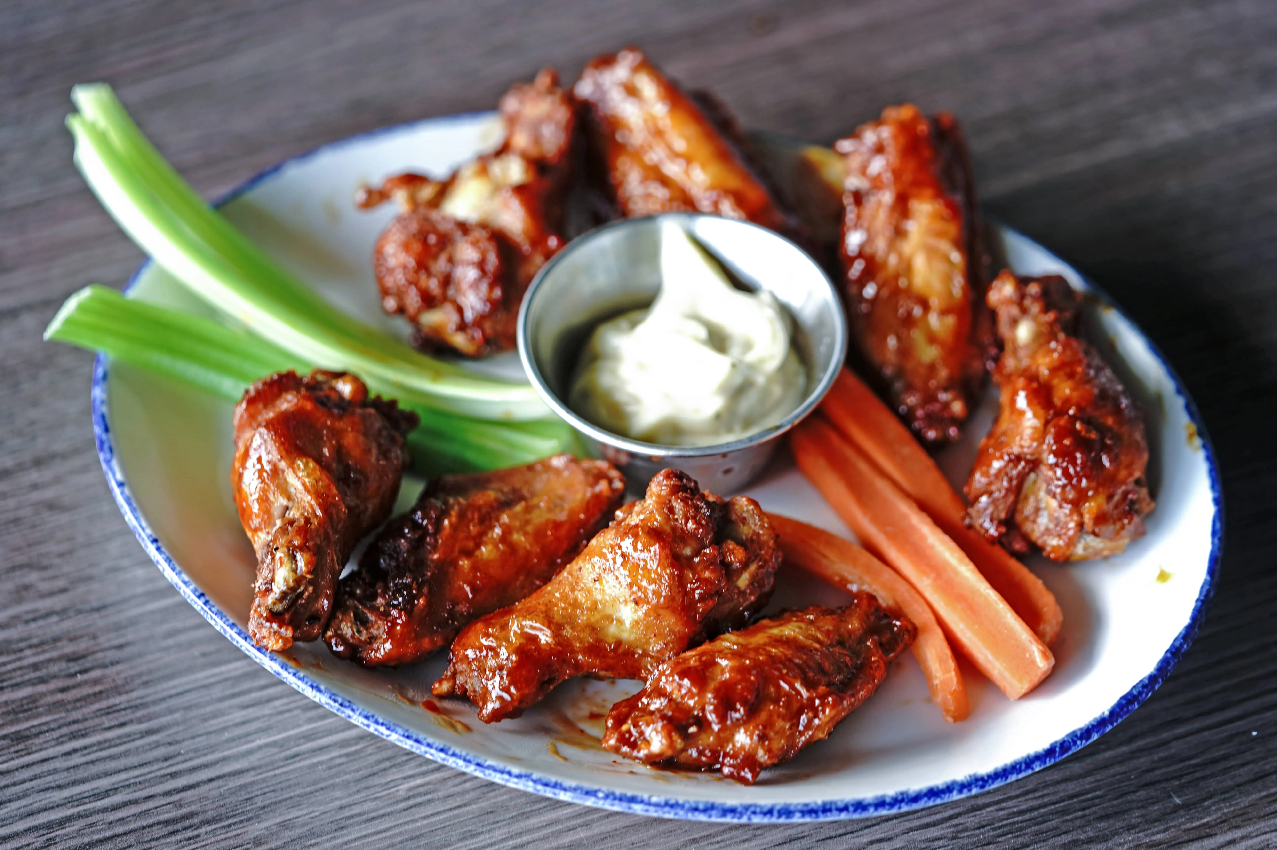 Chicken wings and a side of celery and carrots.