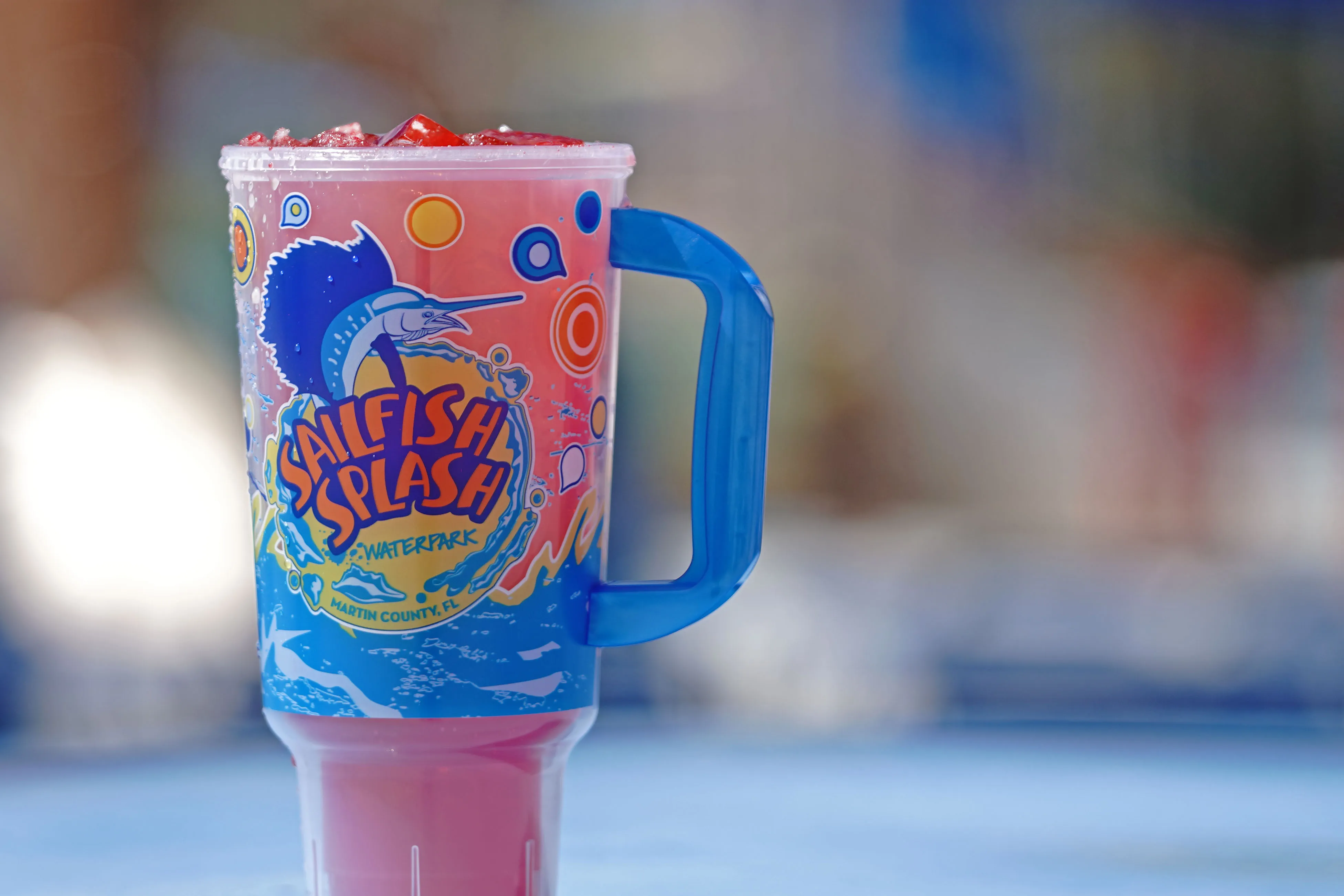 A Sailfish Splash Waterpark souvenir cup filled with fruit punch