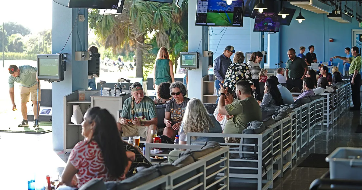 People playing and sitting in the hitting bays at Sailfish Sands Hitting Bays & Restaurant