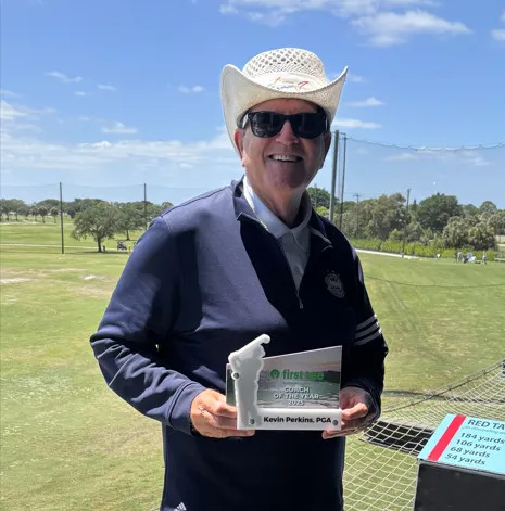 Kevin Perkins holding his 2025 Coach of The Year Award