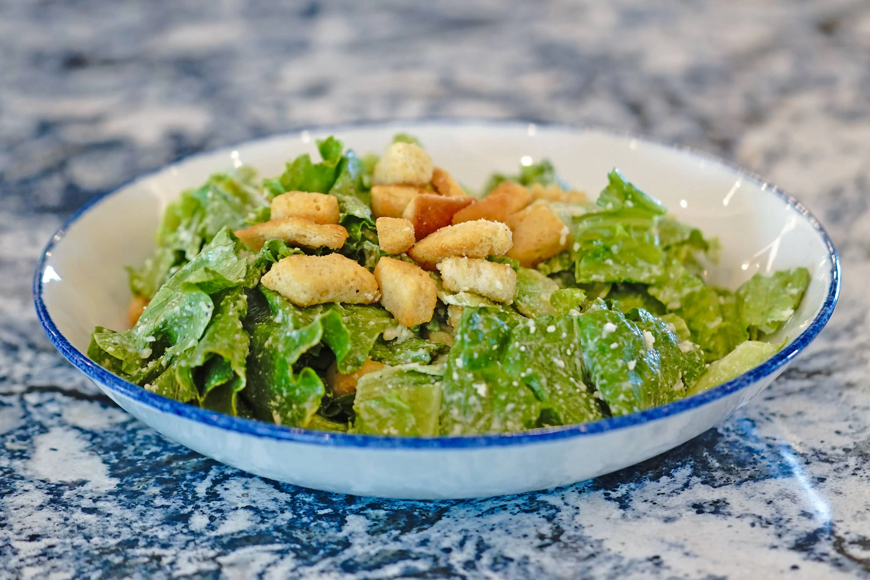 A Caesar Salad topped with croutons