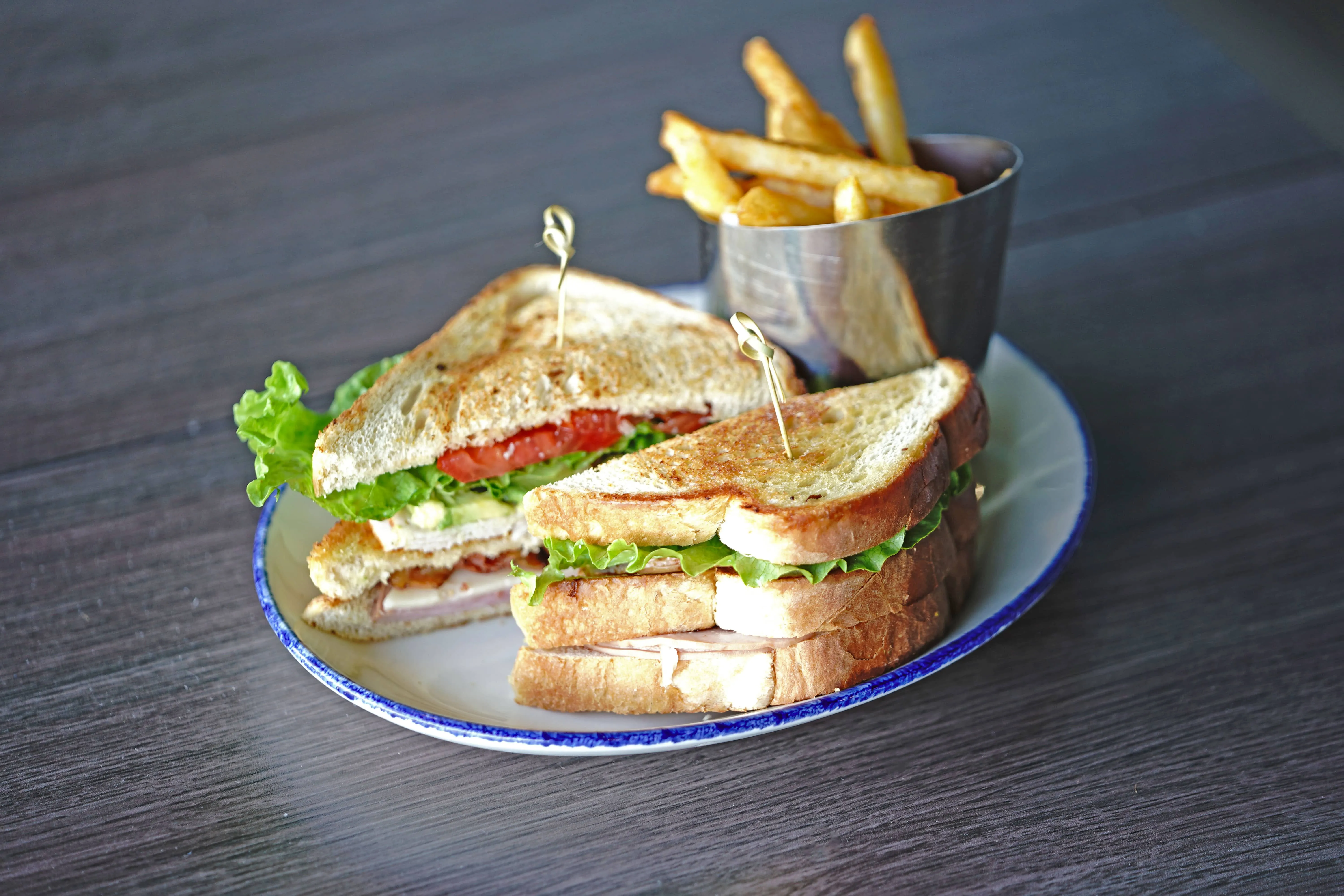 A Sailfish Sands Club Sandwich with a side of fries