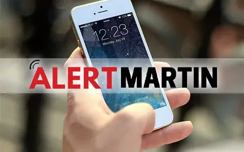 Alert Martin logo and a person holding a smartphone